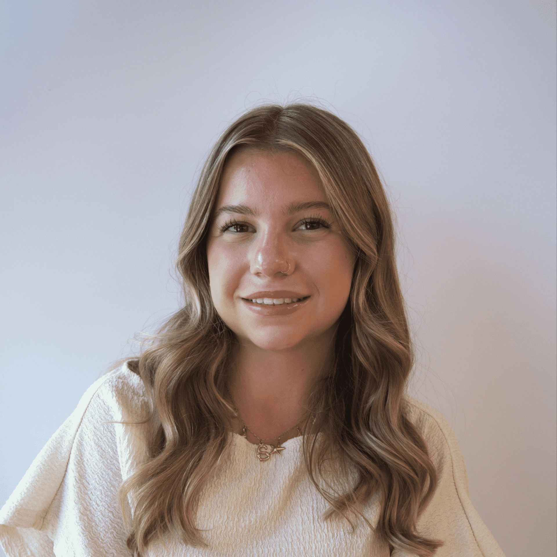 Portrait of Savannah, a professional stylist at Western Blonde Salon, showcasing their expertise and style.