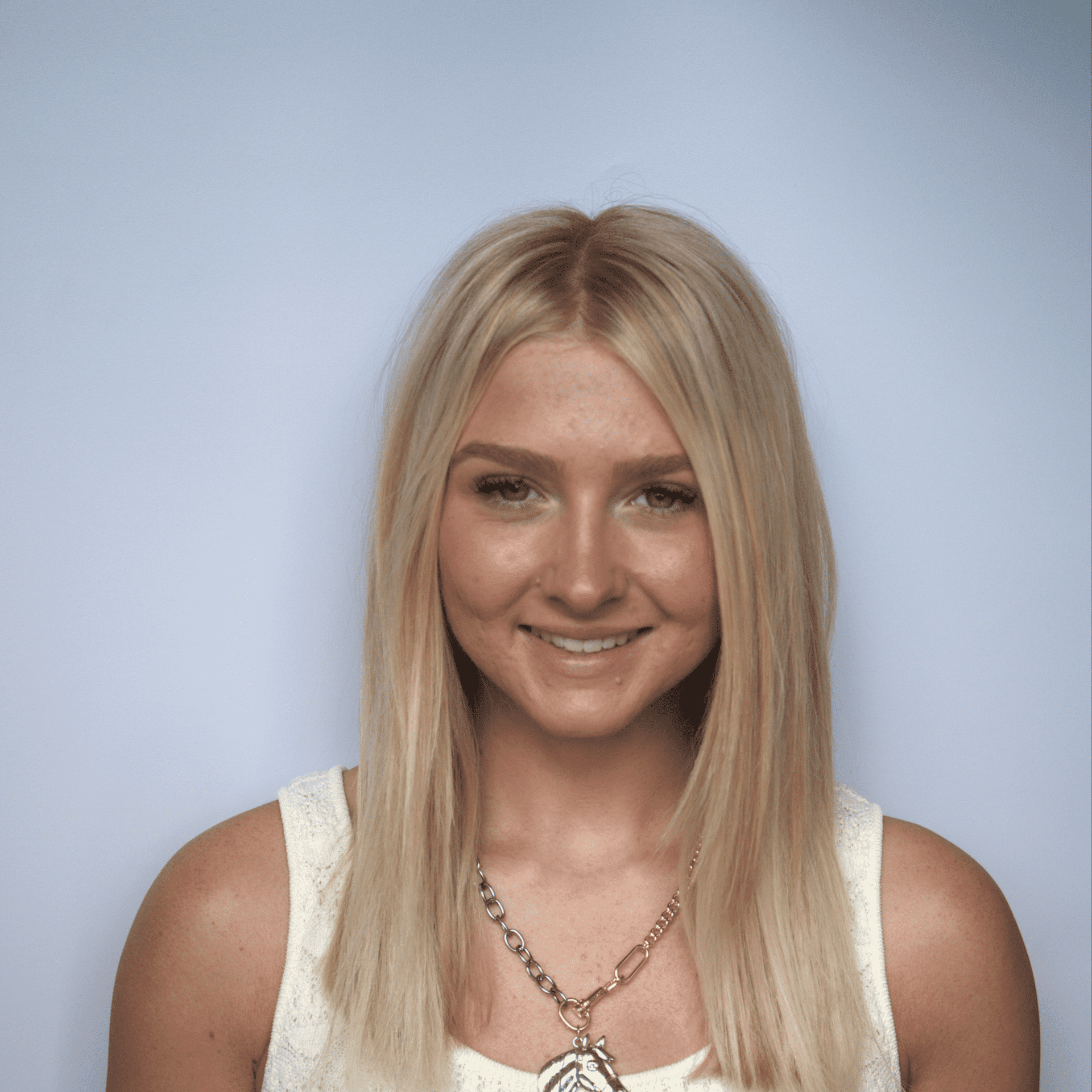 Portrait of Remi, a professional stylist at Western Blonde Salon, showcasing their expertise and style.