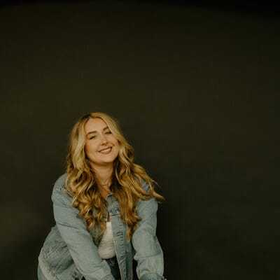 Portrait of Brandi, a professional stylist at Western Blonde Salon, showcasing their expertise and style.