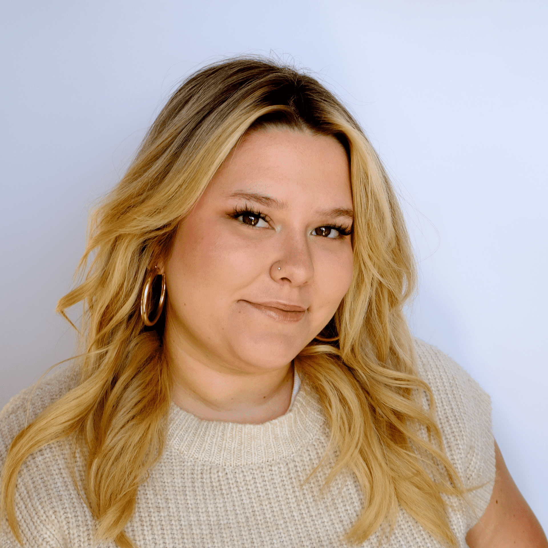 Portrait of Kat, a professional stylist at Western Blonde Salon, showcasing their expertise and style.