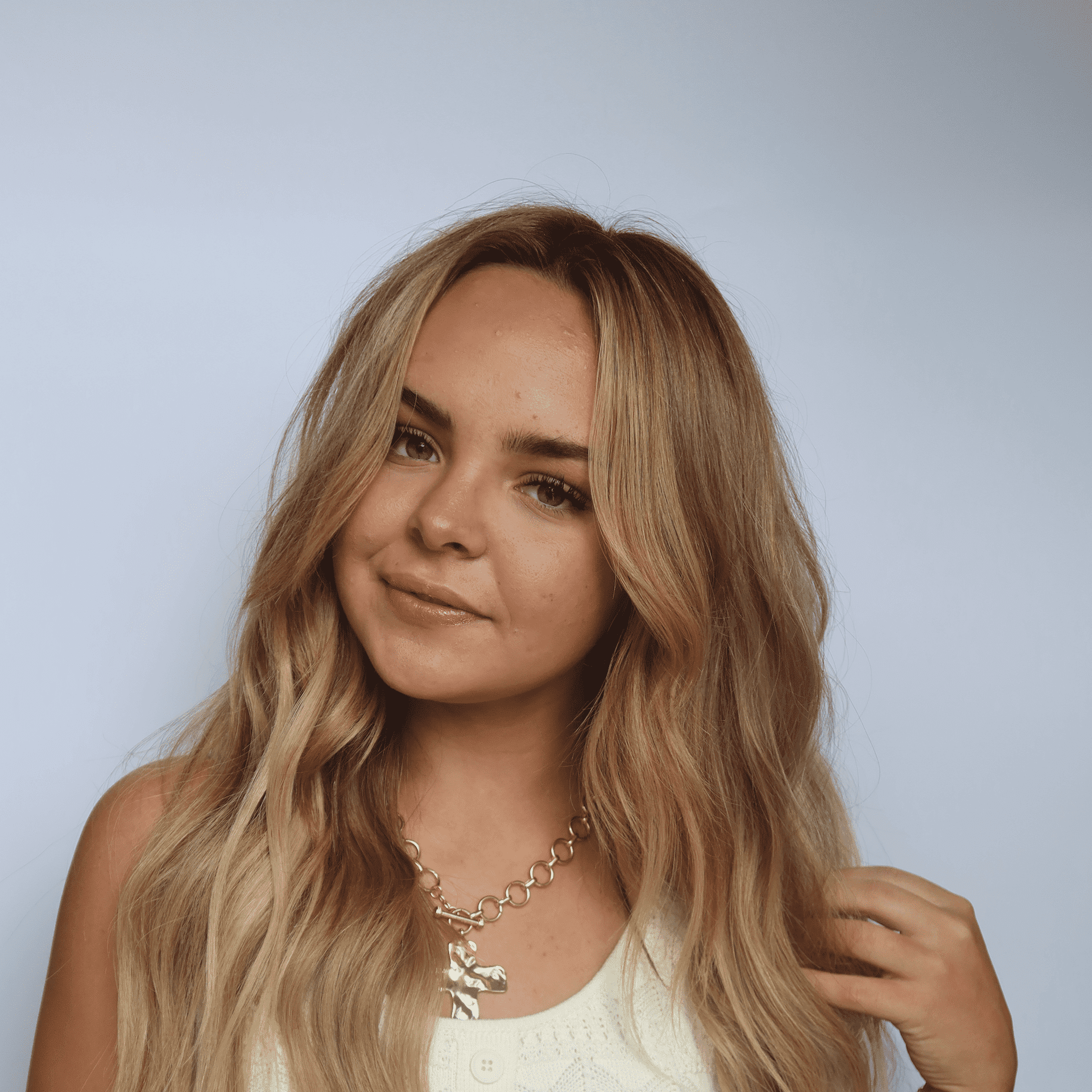 Portrait of Fallon, a professional stylist at Western Blonde Salon, showcasing their expertise and style.