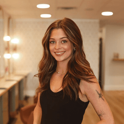 Portrait of Bailey, a professional stylist at Western Blonde Salon, showcasing their expertise and style.